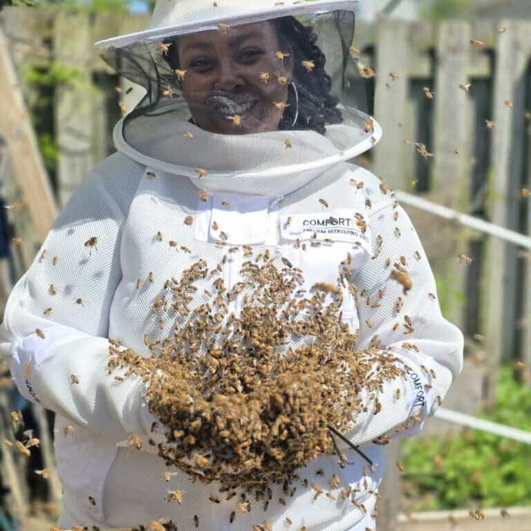 Danie holding thousands of bees